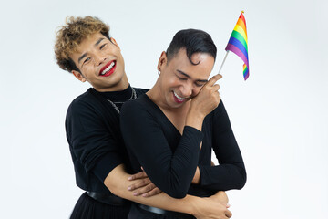 Happy asian gay couple holding pride flag rainbow isolated white color background and looking at...