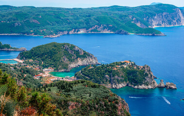 Scenic landscape of the Paleokastritsa era in Corfu, Greece, with crystal clear water and rocky coves. Breathtaking view from Angelokastro castle.