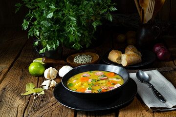 Hearty rustic pea soup with bacon and sausage