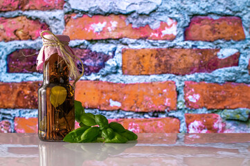 a bottle of pickled, canned herbs and basil leaves