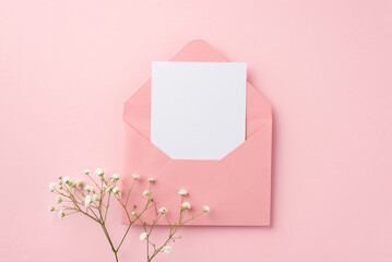 Party invitation concept. Top view photo of open pink envelope with paper sheet and white gypsophila flowers on isolated pastel pink background with blank space