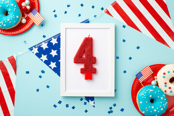Obraz premium Fourth of July concept. Top view photo of photo frame with number 4 candle national flag garland confetti and plates with donuts and candies on isolated pastel blue background