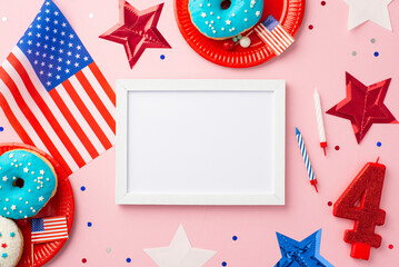 Obraz premium Fourth of July concept. Top view photo of photo frame US national flag stars number 4 candle plates with donuts candles and confetti on isolated pastel pink background with blank space