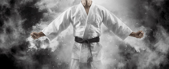 Man in white kimono with black belt © Andrey Burmakin