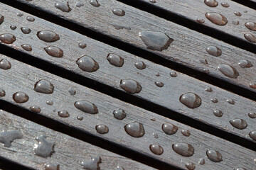 Rain drops on wooden table after rain. Selective focus