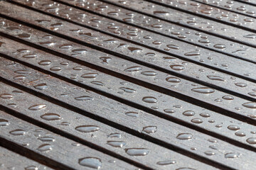 Rain drops on wooden table after rain. Selective focus