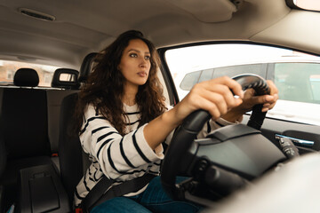 Fototapeta na wymiar Arabic Female Driver Driving Sitting In New Car