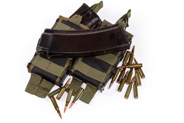 Military tactical pouches for magazines among the rifle cartridges