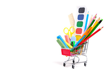 School supplies and stationery in a shopping basket white background.Preparing child for school...