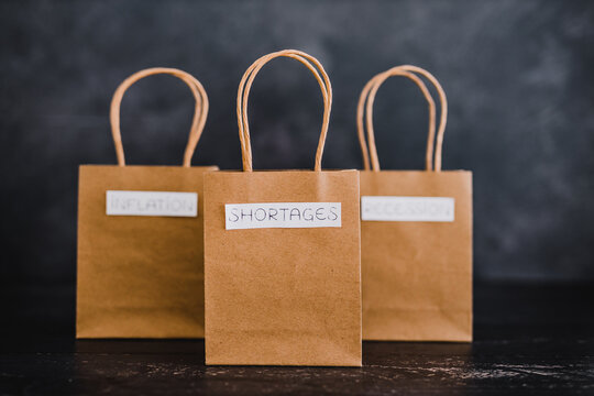 economy after covid, inflation shortages and recession texts on shopping bags