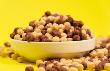 Corn sweet balls on a yellow background. Quick dry breakfasts, side view.