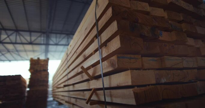 The loader brings wood in a pallet. Loading business timber in a warehouse. Woodworking industry. High quality 4k footage