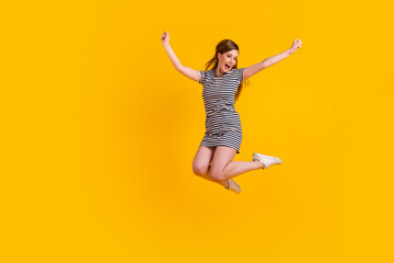 Fototapeta na wymiar Full length photo of young excited girl jump up celebrate luck awesome champion isolated over yellow color background