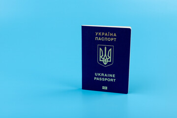 Ukrainian passport with a golden trident symbol on blue background. Biometric Ukraine passport id...