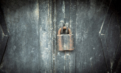 Metal padlock on the metal door.
