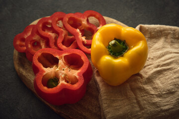 yellow and red peppers on the cutting board