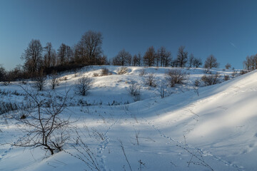 Winter nature landscape. Snowy slopes sunlight. Photo for decoration and design