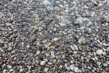 Rocky beach and pebble stones at sea
