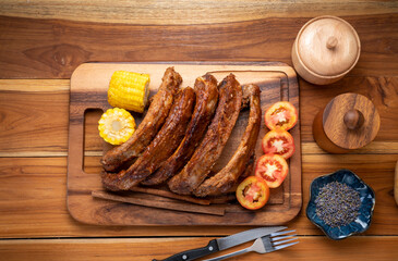Grilled sliced barbecue pork ribs on wooden plate, Pork Spare Ribs with Barbecue seasoned spicy...