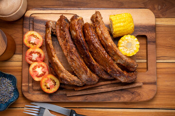 Grilled sliced barbecue pork ribs on wooden plate, Pork Spare Ribs with Barbecue seasoned spicy...