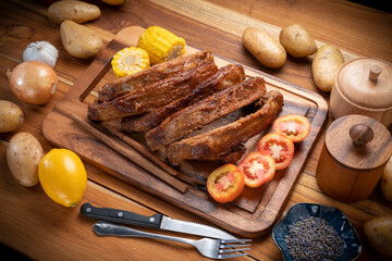 Grilled sliced barbecue pork ribs on wooden plate, Pork Spare Ribs with Barbecue seasoned spicy...