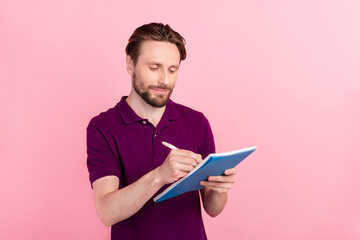 Photo of young guy write notes to-do list manager economist expert isolated over pink color background