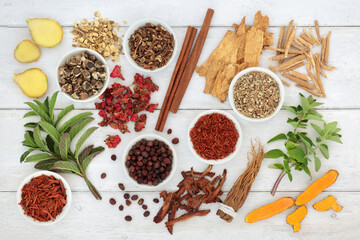 Herbs and spices fresh and dried for immune system boost on rustic wood. Health care food concept high in powerful antioxidants, anthocyanins, vitamins and minerals. 