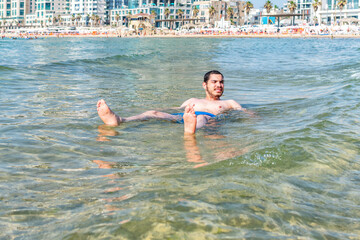 Young man enjoying the sea on summer holiday