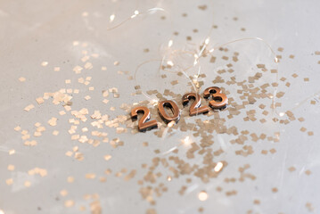 Holiday background Happy New Year 2023. Numbers of year 2023 made by gold candles on bokeh festive sparkling background. celebrating New Year holiday, close-up. Space for text