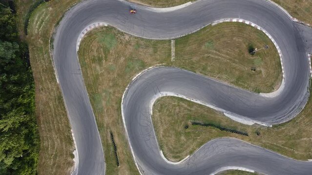 A stunning aerial view of a go kart track while a driver races.
