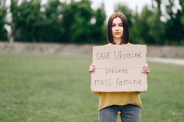 A civilian protests against the war in Ukraine. Girl on the background of nature