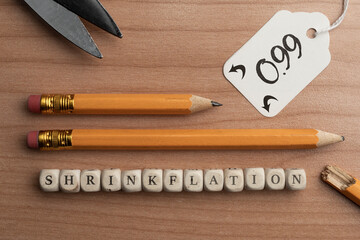 Shrinkflation concept: two pencils of different lengths sold for the same price. Shrinkflation is a...