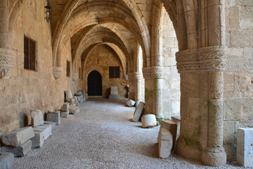 ancient arched hall with stone walls, columns and windows