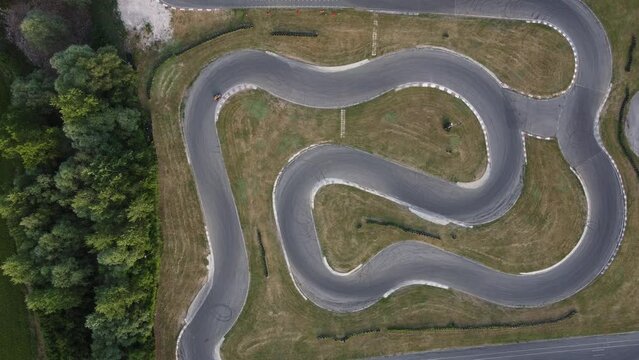 A stunning aerial view of a go kart track while a driver races.