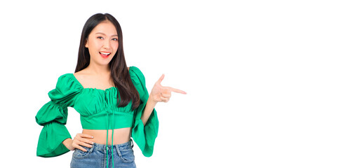 Attractive beautiful positive happy smile asian woman hands point up and pose with empty space wearing green shirt and jeans.