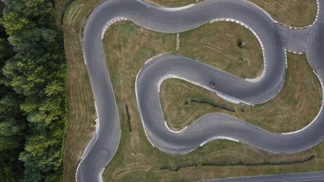 A stunning aerial view of a go kart track while a driver races.