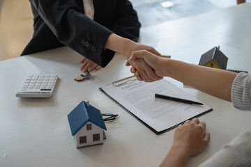 Guarantees, Mortgages, Signings, contract, agreement concept, Real estate agents shake hands with clients after signing the contract and congratulate them after reaching an agreement.