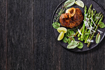braised osso buco with grilled asparagus, top view