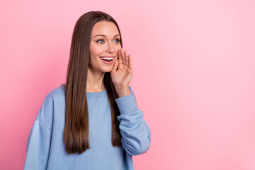 Portrait of attractive girly cheerful girl saying good news copy space isolated over pink pastel color background