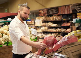 Man buy fruits and vegetables at supermarket