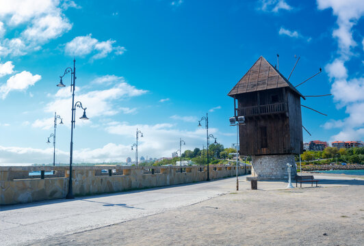 nessebar, bulgaria - sep 2, 2019: old windmill on the embankment at the sea shore. popular travel destination. sunny weather in velvet season