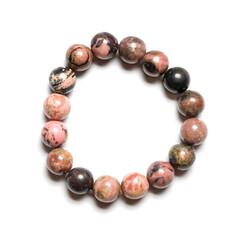 Rhodonite bracelet on white background. Collection of natural gemstones accessories. Studio shot