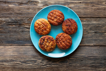 Grilled juicy cutlets in a dish on a wooden table. Grill, barbecue