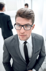close up.confident young businessman on blurred office background