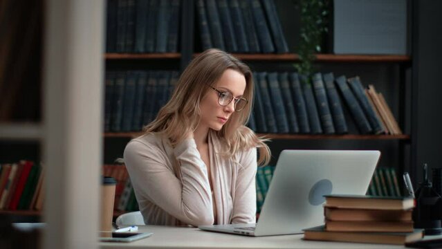 Tired woman science professor teacher working laptop at library feeling neck pain overworked