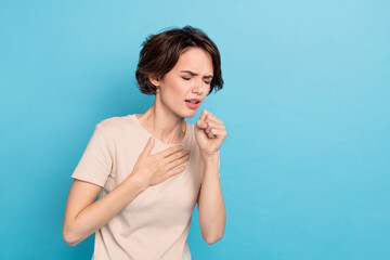 Photo of young lady have covid 19 touch her chest coughing sneezing feel bad isolated on blue color...