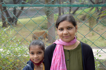 AN INDIAN MOTHER AND HER DAUGHTER IS ENJOYING IN ZOO HYDERABAD ELANGANA INDIA