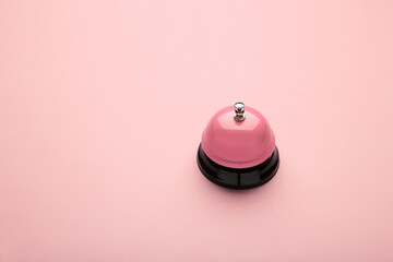 Pink service bell on a pink background. - obrazy, fototapety, plakaty