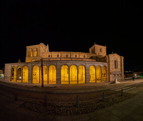 View of the basilica of San Vicente in front of the Avila wall at night, one of the jewels of Ávila. This Romanesque temple was built between the 12th and 13th centuries.
