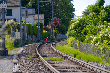 Fototapeta premium Closed railway track because of construction works with red and white sign at City of Zürich on a sunny spring afternoon. Photo taken May 18th, 2022, Zurich, Switzerland.